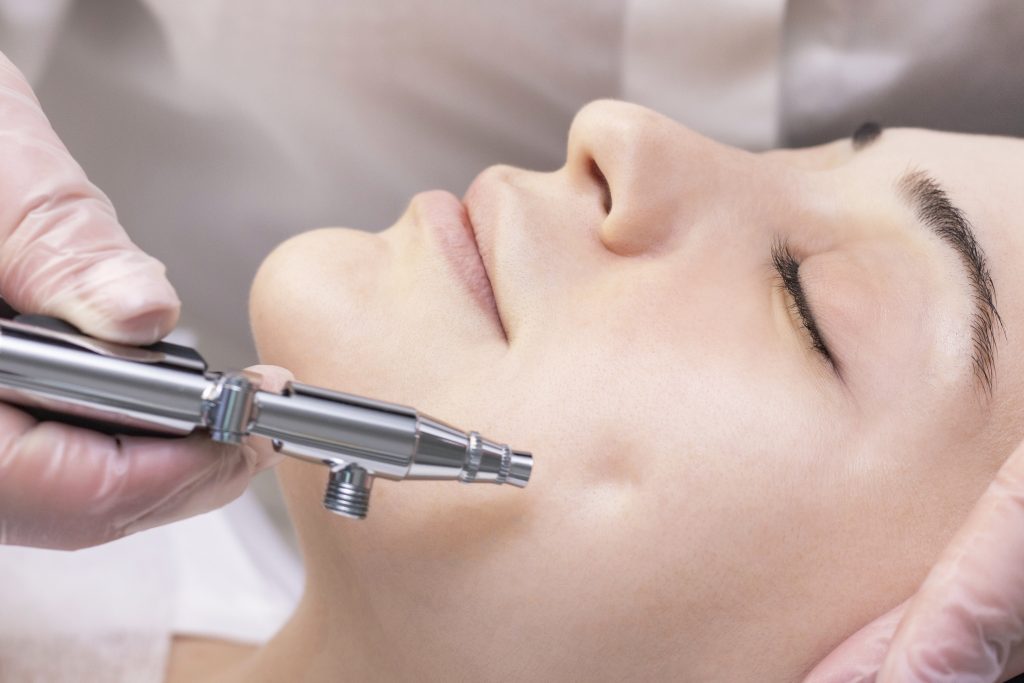 Oxygen mesotherapy. Aquapilling. Cosmetic peeling procedure. Non-injection mesotherapy for a young girl in a beauty salon.